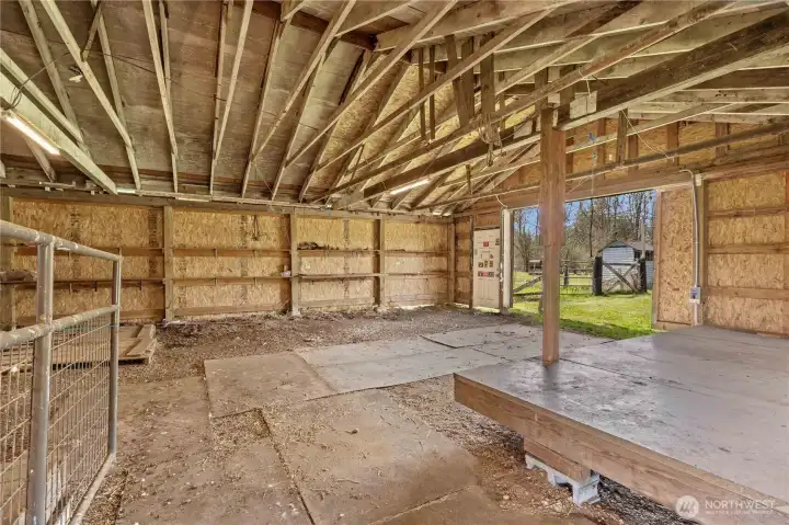 Barn interior highlighting structure and capacity, ideal for equestrian setup or multi-use functionality.