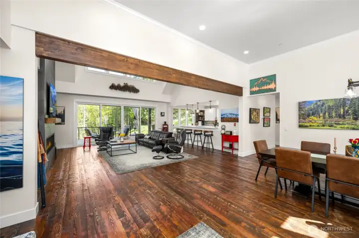 Expansive great room and large entryway for greeting guests showcasing the impressive custom finished real circular sawn DougFir hardwood floors.