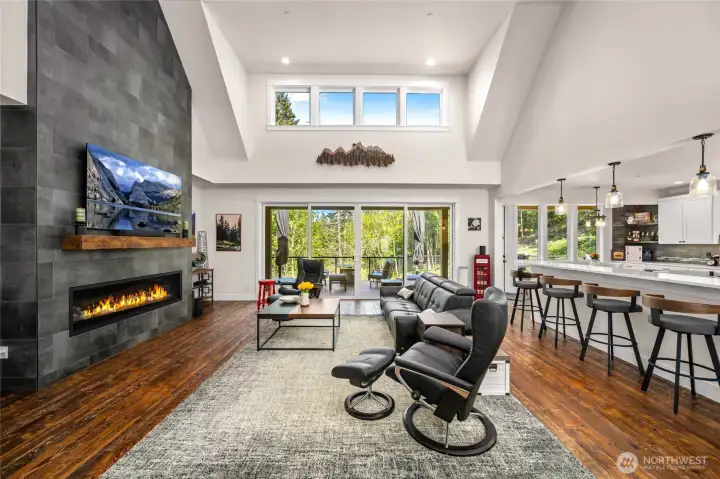 Large greatroom with oversized glass slider to feel connected to the beautiful surrounding nature.