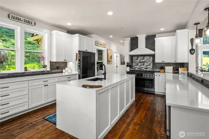 Kitchen Island and Peninsula bar make entertaining easy. Backsplash is custom cut and polished from the fireplace porcelain tile to truly blend the spaces.