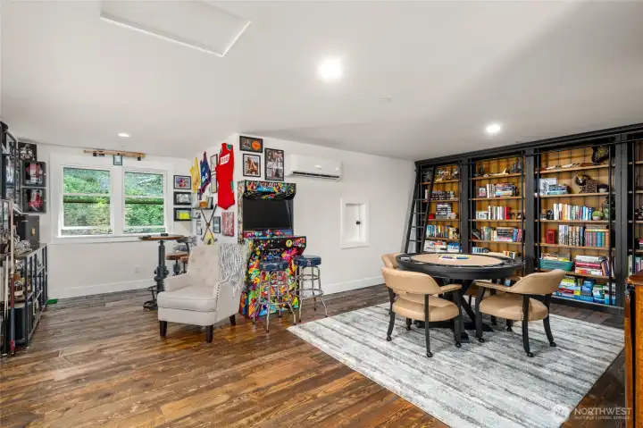 An excellent library feature with black metal ladders complete the modern rustic appeal of this space.