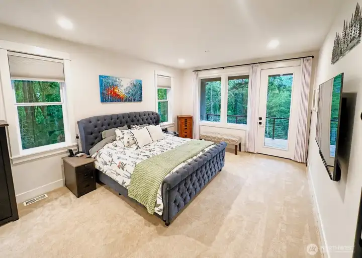 Perfectly sized primary suite with oversized windows and private entry onto main floor deck.