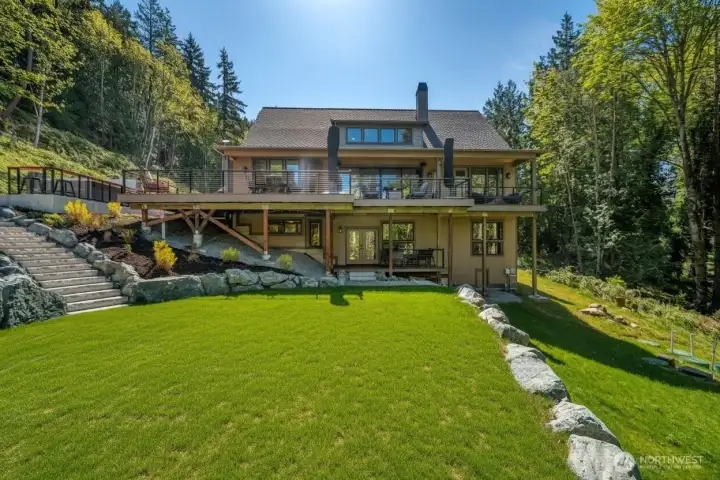 The backend showcases the abundance of windows and outdoor entertaining spaces.