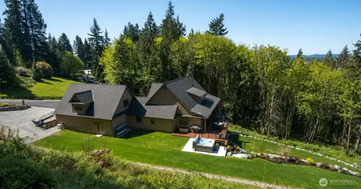 Multiple private hiking trails exist that lead up the mountainous 5 acres to enjoy the PNW from your own home with views of Fidalgo Bay from multiple arease around the property.