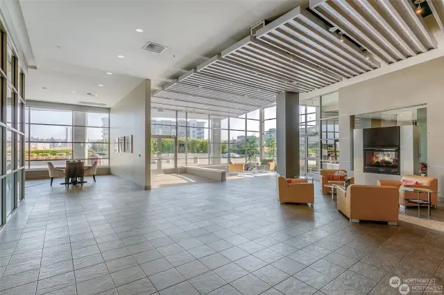 The glass walled Esplanade lobby is anchored by a gas fireplace shown to the right.