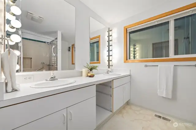 The primary bath has a dual sink bathroom which is spacious and very bright.