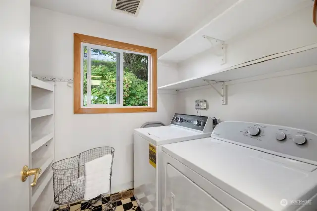 The laundry room is just off the kitchen and has pantry storage area.