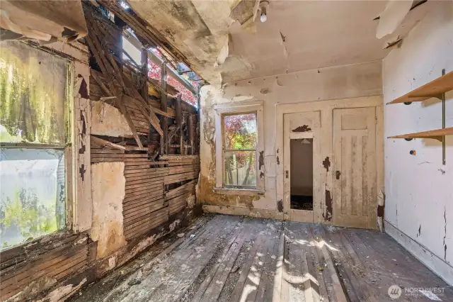 The bonus room off the living room has damage to the exterior wall.