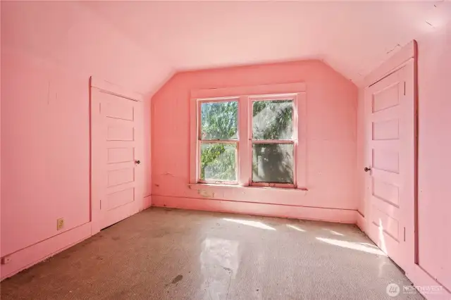This pink room is the second bedroom in the upper level.