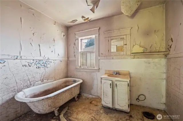 The bathroom has no running water; the toilet has been removed.