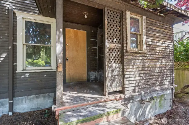 Out of the back door of the home is the level and open backyard, offering potential space for a larger new build.