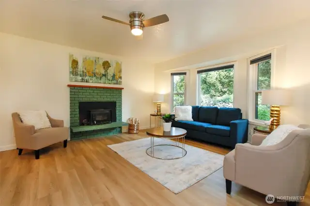Open Living room with wood stove, new floors and paint