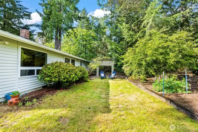 The flat back yard is perfect for games, barbecues, and relaxing in the sun.