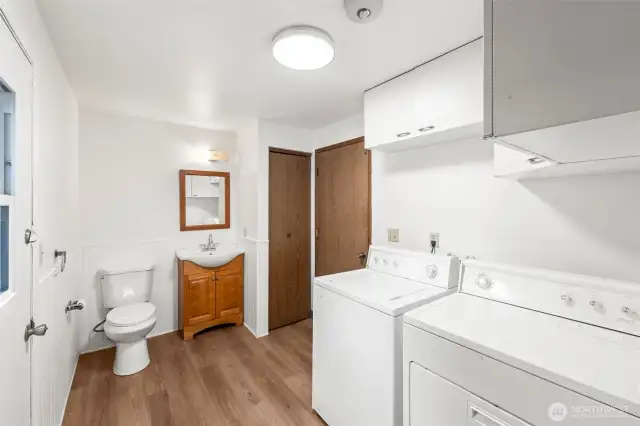 Half bath with laundry room, garage door, and patio door with pet access.