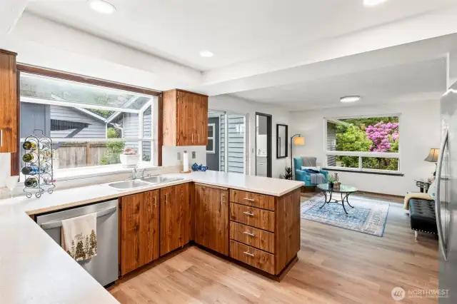 Updated kitchen features a large sunny solarium window.