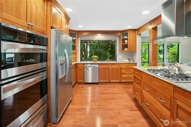 Chef's delight kitchen offers slab granite counters, cherry cabinetry, stainless appliances, and loads of storage!