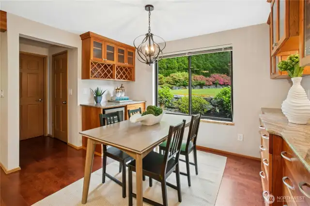 The kitchen nook offers glass front cabinetry, a wine fridge and views to the backyard. The large walk in pantry is adjacent!