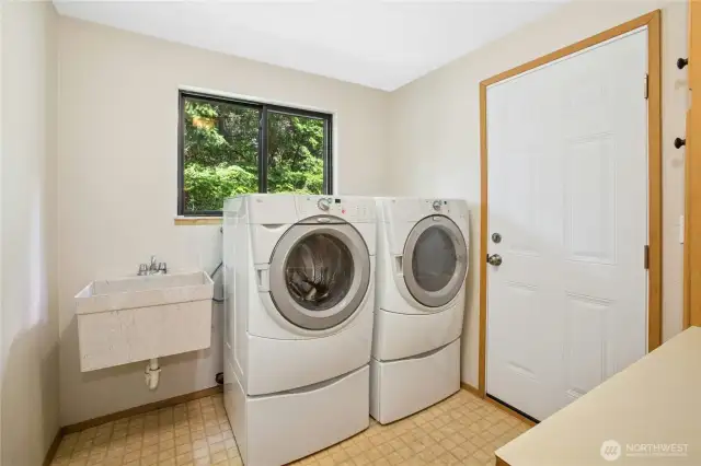 Large laundry room with door to backyard and plenty of storage!