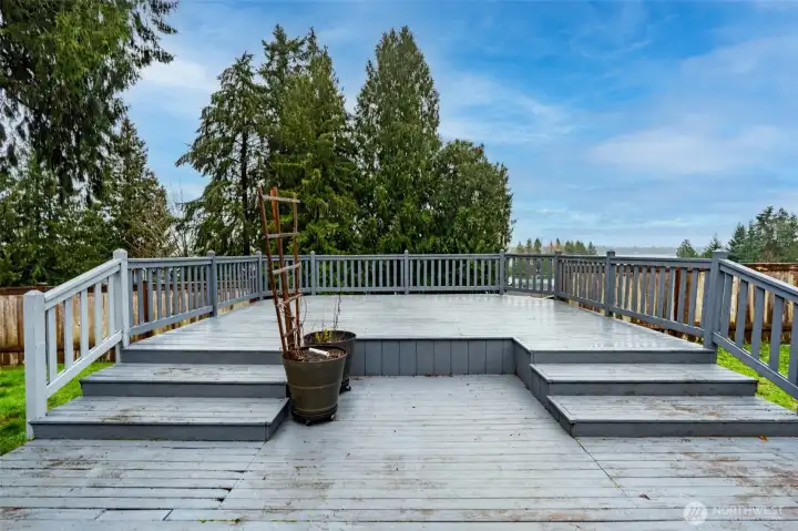 Tiered deck has so much room for outdoor dining space and conversation area overlooking the lake.