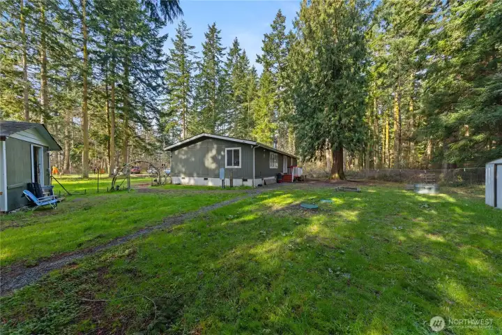 Back of home with outbuilding