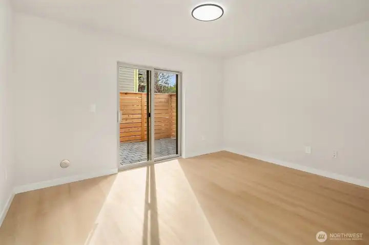 First floor bedroom boasts loads of natural light and access to private patio