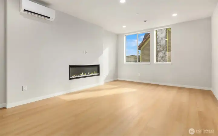 great sized living room with cozy fireplace and ample room for dining table