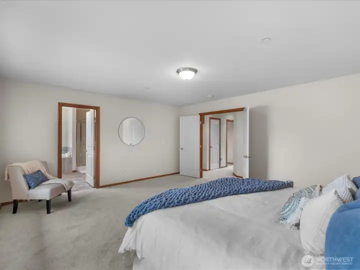 This expansive bedroom offers a seamless flow into a private ensuite bathroom, creating a true retreat with comfort and privacy. The generous layout provides exceptional flexibility for a sitting area, workspace, or additional furnishings. Dual entry doors add both convenience and a touch of elegance.