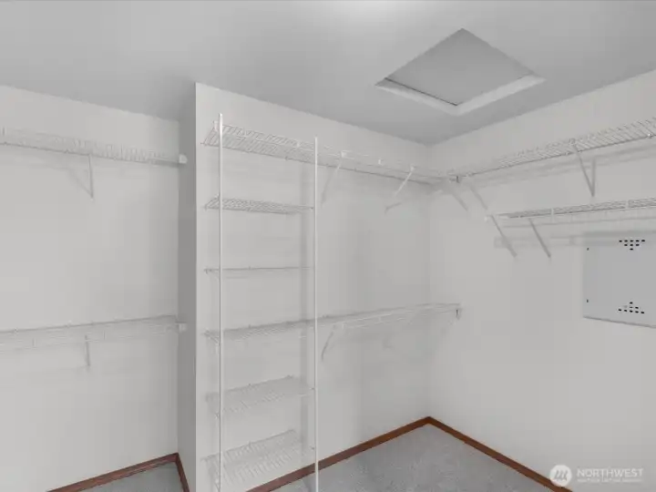 Generously sized primary walk-in closet designed for effortless organization and everyday convenience.