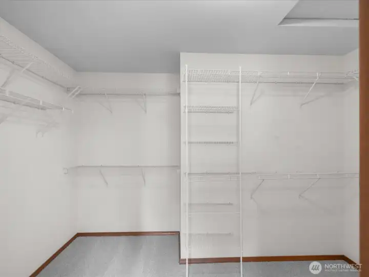 Expansive primary walk-in closet with abundant storage.