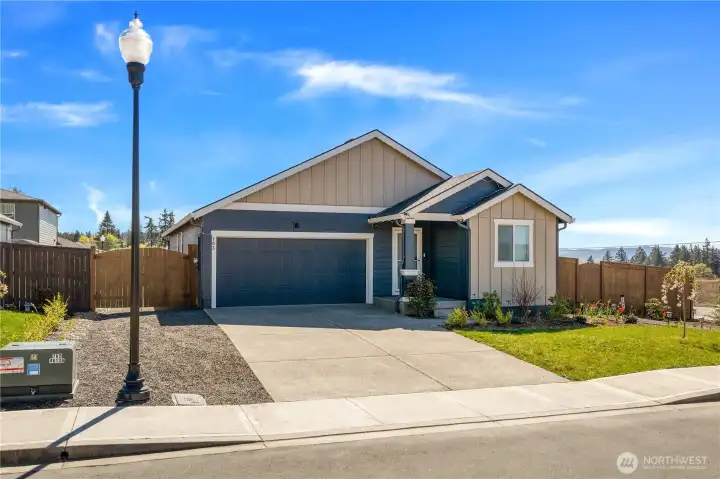 Wide driveway with double gate leading to more parking for RV, boat, or trailer.