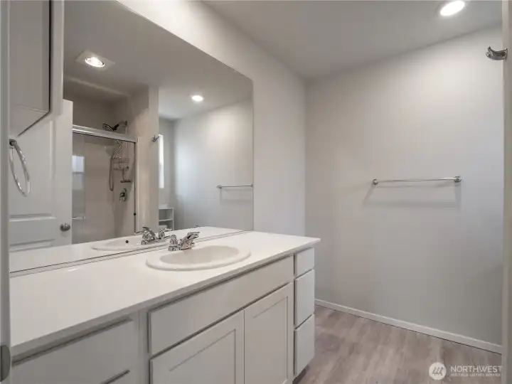 The primary suite includes spacious private en suite with beautiful LVT flooring and quartz countertops.