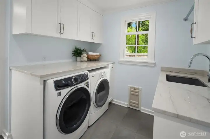 the laundry area is off the mudroom and garage on the main floor.