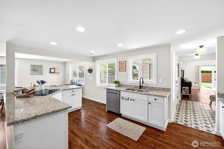 Kitchen features white cabinets, built-in stainless appliances and granite countertops.