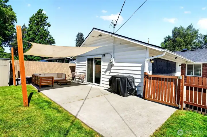 Spacious patio with shade cover. Lovely space for outdoor entertainment.
