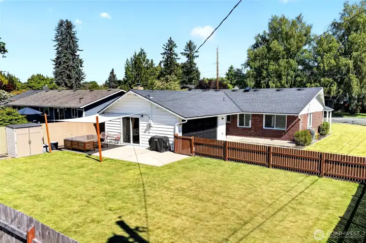 The fenced backyard feels huge. So much room to play & entertain!