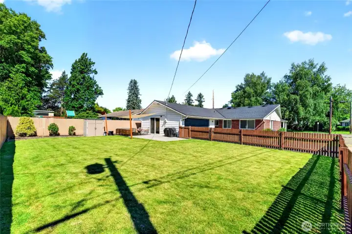 The fenced backyard feels huge. So much room to play & entertain!
