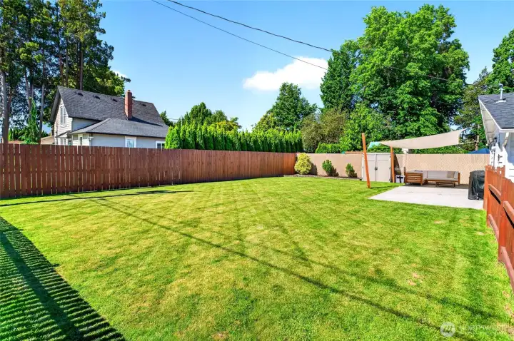 The fenced backyard feels huge. So much room to play & entertain!