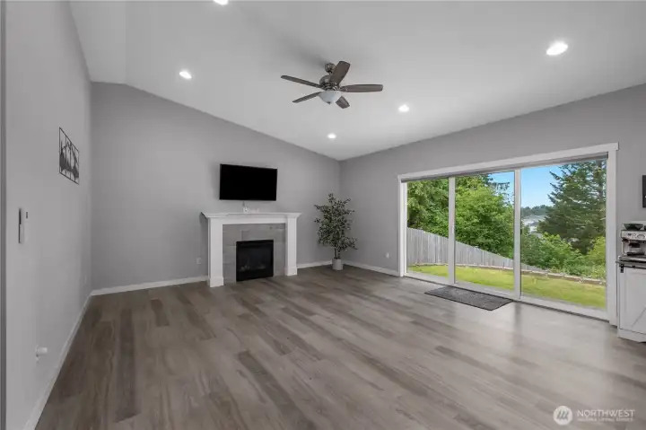 GR - Spacious Great Room with vaulted ceiling, gas fireplace, recessed lighting, and large slider to the backyard.
