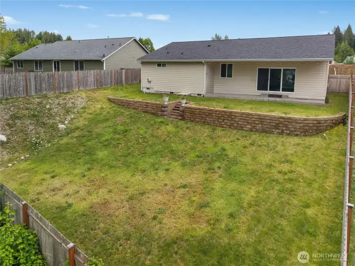 Enjoy BBQs, play, pets, and sunsets in the spacious fenced backyard with covered patio.
