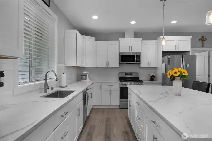 Cook and host in a fresh, modern kitchen with storage, workspace, and included appliances.