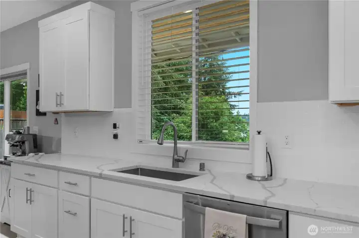 Enjoy everyday kitchen prep with bright natural light and peaceful backyard views from the sink.
