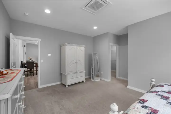 Primary bedroom with walk-in closet access, private bath access, and individual mini-split for comfort.