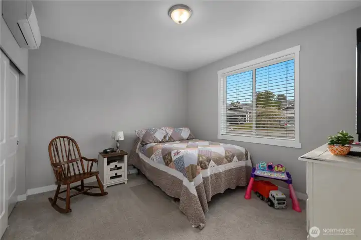 BR 2 - Comfortable bedroom with carpet, large window, closet, and individual mini-split for heat and A/C.