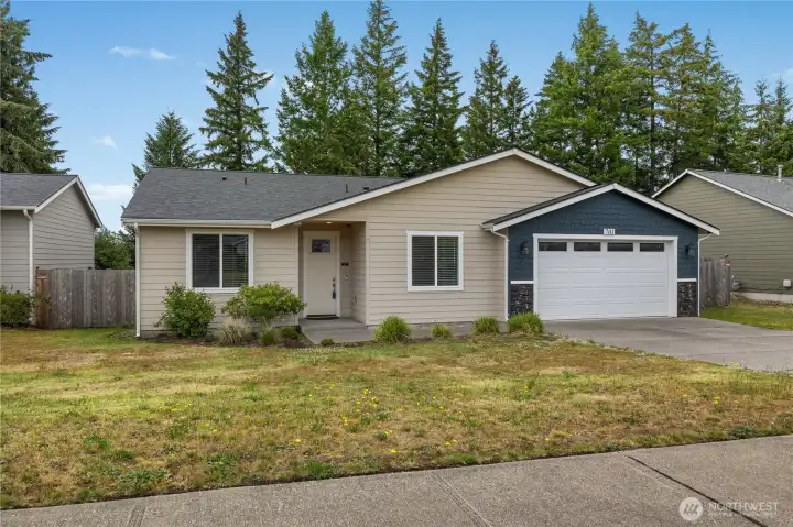 Beautifully maintained rambler with covered entry, fenced side yard, and spacious driveway parking.