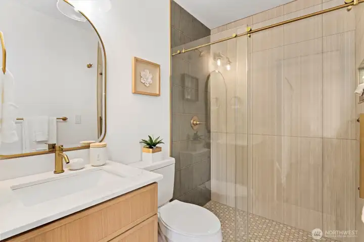 Primary Bathroom with floor to ceiling tiles, frameless glass shower door, and ambient lighting Primary Bathroom with floor to ceiling tiles, frameless glass shower door, and ambient lighting