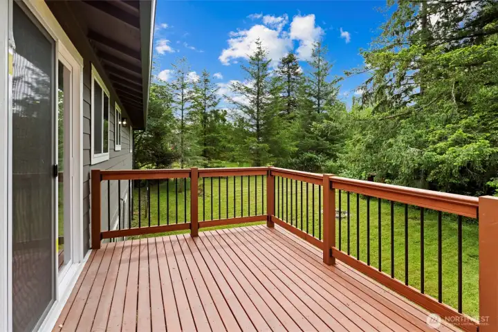 Back deck overlooking large flat lot in mature and peaceful setting Back deck overlooking large flat lot in mature and peaceful setting