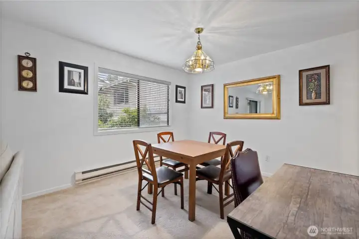 Spacious dining area with large windows that fill the space with natural light. Spacious dining area with large windows that fill the space with natural light.
