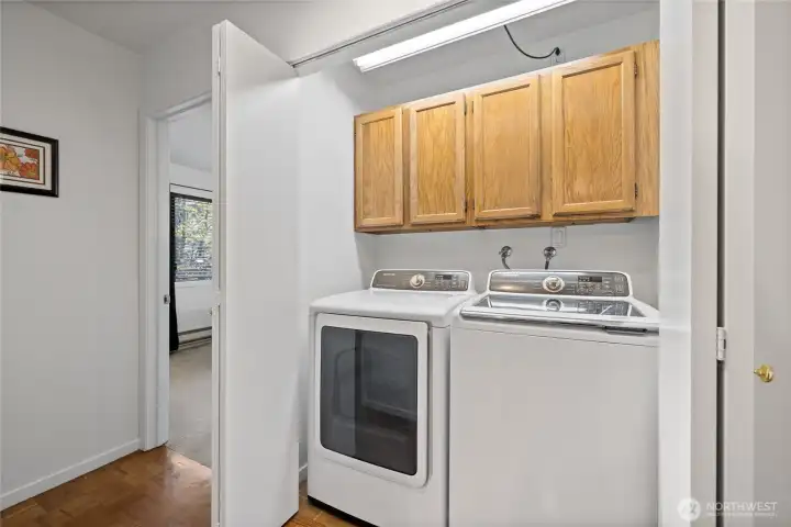 Convenient in-unit laundry with a side-by-side washer and dryer, plus additional storage cabinets. Convenient in-unit laundry with a side-by-side washer and dryer, plus additional storage cabinets.