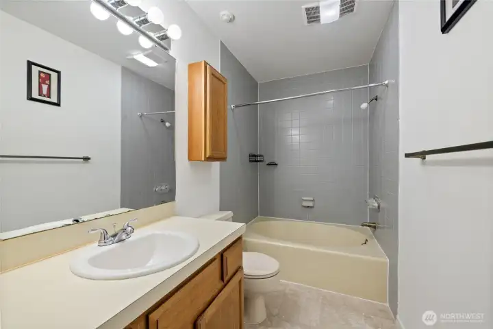 Hall bathroom featuring a large vanity and an oversized soaking tub. Hall bathroom featuring a large vanity and an oversized soaking tub.