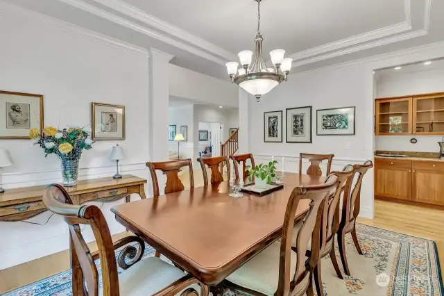 Dining Room offers coffered ceilings, wainscotting and wood wrapped windows